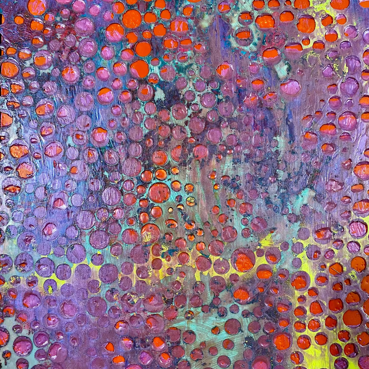 Abstract artwork with circular patterns in purple, orange, and yellow.